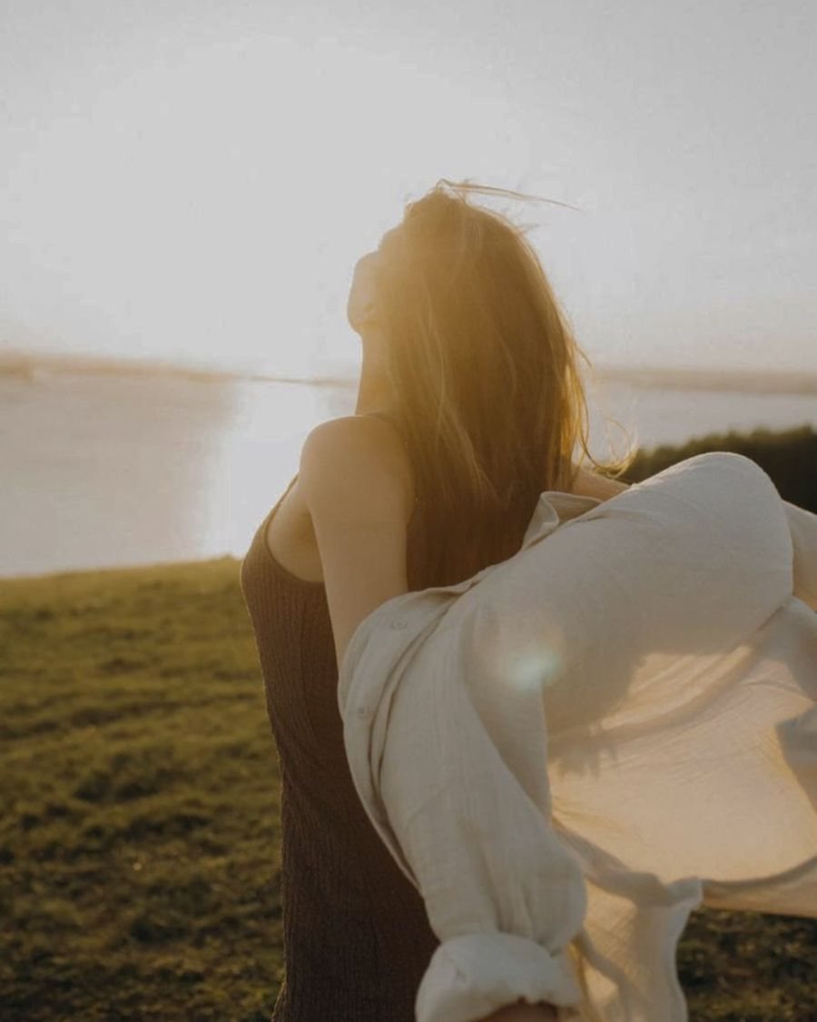 Woman with a flowing shirt at sunset